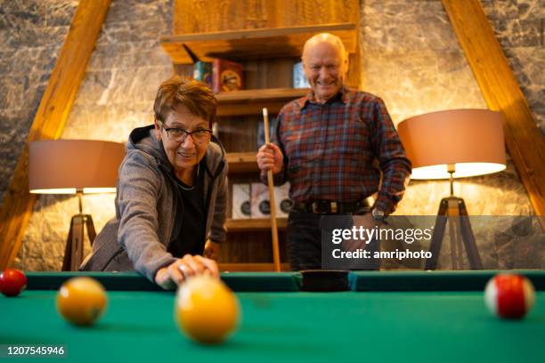 happy seniors playing pool - billiard ball game stock pictures, royalty-free photos & images