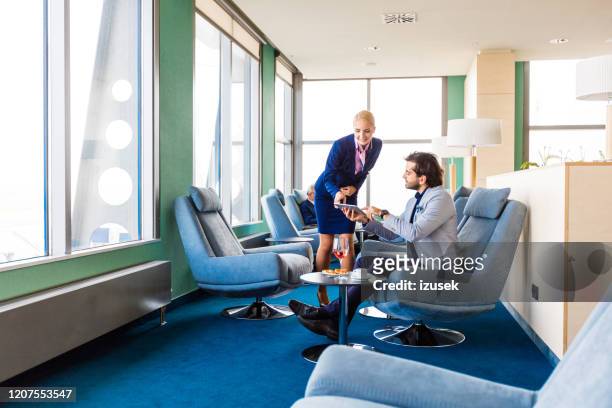 airport client service manager talking with businessman in vip lounge - tourist asking stock pictures, royalty-free photos & images