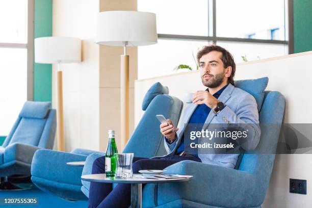 businessman waiting for flight in the aiport vip lounge - star style lounge imagens e fotografias de stock