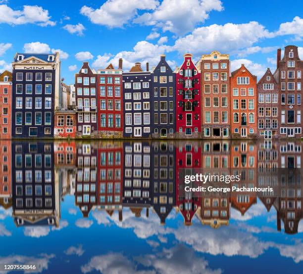 architecture reflection on a canal in amsterdam, holland - estrecho fotografías e im�ágenes de stock