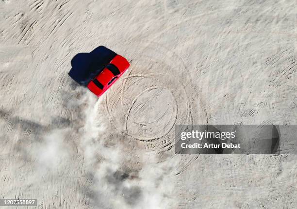 aerial view of red muscle car doing donuts in the desert of california. - aerial desert stock pictures, royalty-free photos & images