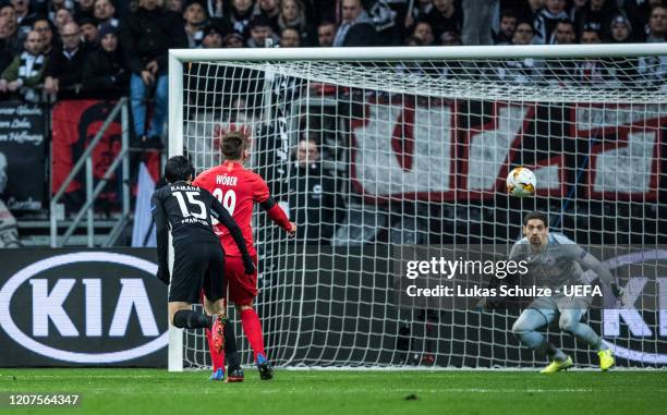 Daichi Kamada of Frankfurt challenges for the ball with Maximilian Wöber of Salzburg and scores his team's third goal against Goalkeeper Cican...