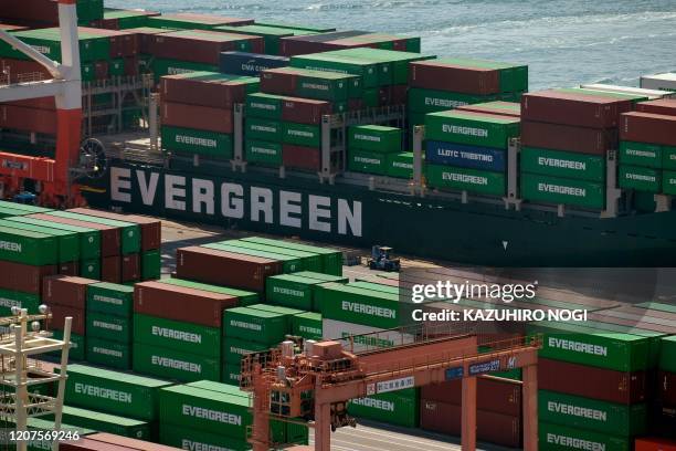 Containers are seen at the international cargo terminal at the port of Tokyo on March 18, 2020. - Japan's imports from China almost halved last month...