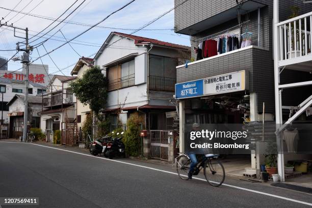 Cyclist travels along a road at a residential area in the Ota district of Tokyo, Japan, on March 17, 2020. Japan's Prime Minister Shinzo Abe is still...