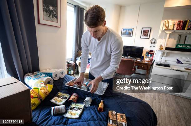 Zach Lane has stocked up on non-perishable food and toilet paper, which he stores in his room in the group house he shares with three other friends...