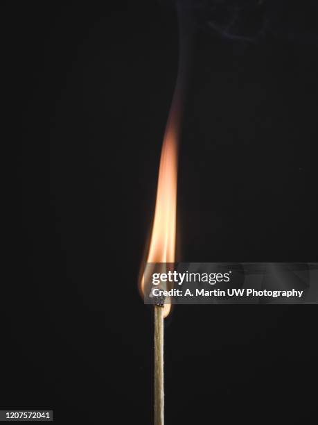 a burning matchsticks on black background - candle flame stockfoto's en -beelden