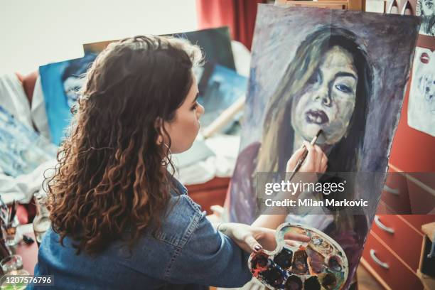 creative young artist painting at home - oil painting people stock pictures, royalty-free photos & images