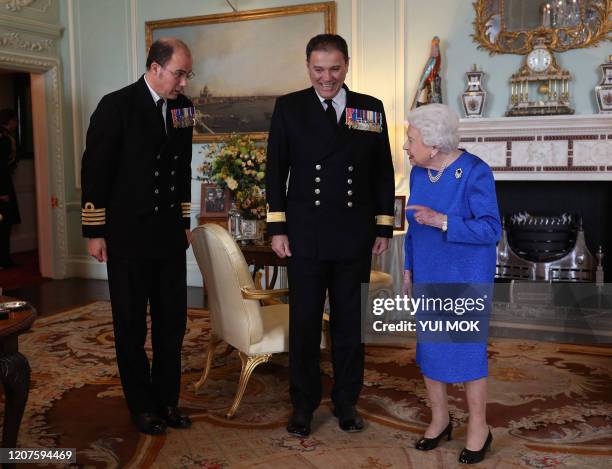 Britain's Queen Elizabeth II receives outgoing Commanding Officer, HMS Queen Elizabeth, Commodore Steven Moorhouse and incoming Commanding Officer,...