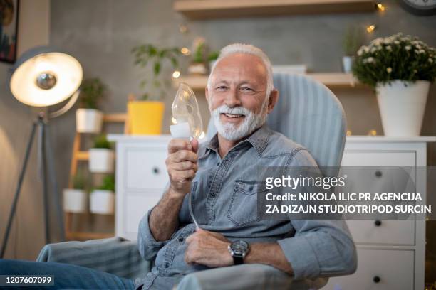 senior inhalation therapy in progres. - inhalation stock pictures, royalty-free photos & images