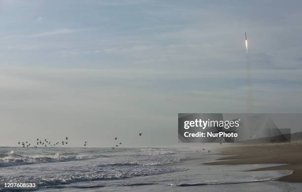 SpaceX Falcon 9 rocket carrying 60 Starlink satellites forms a vapor cone after launching from pad 39A at the Kennedy Space Center in Florida as seen...