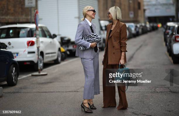 Viktoria Rader wearing a Bottega Veneta pouch and heels and a Max Mara full look and Lisa Hahnbück outside Max Mara during Milan Fashion Week...