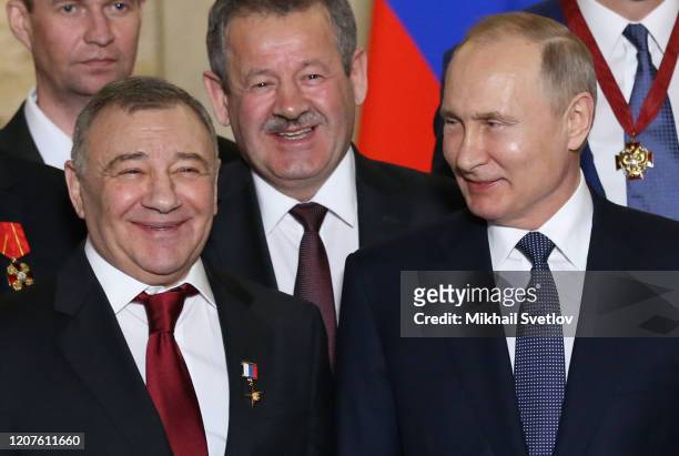 Russian President Vladimir Putin looks on billionaire and businessman Arkady Rotenberg during the awarding ceremony at the museum on March 18, 2020...