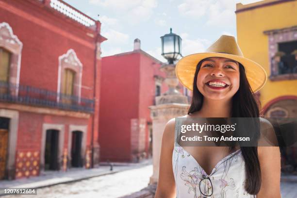 young woman in straw hat standing in historic city center - guanajuato city stock pictures, royalty-free photos & images