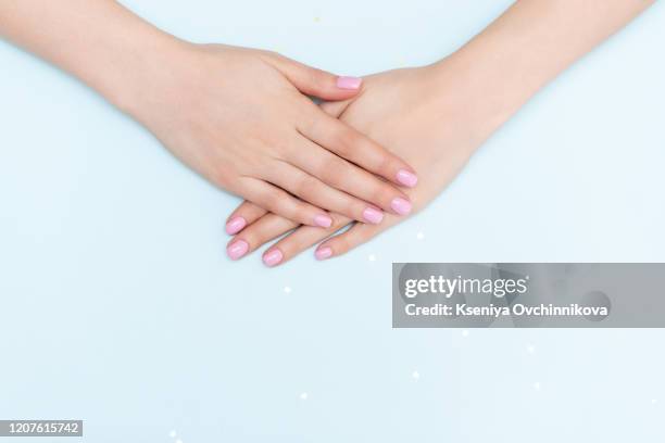 stylish trendy female manicure. beautiful young woman's hands on pink and blue background. - acrylic fiber stock pictures, royalty-free photos & images