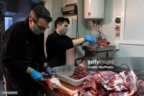 Employees of a butcher shop, carry out their work in the city of Santander, Spain on March 18, 2020 complying with the safety and hygiene protocols...