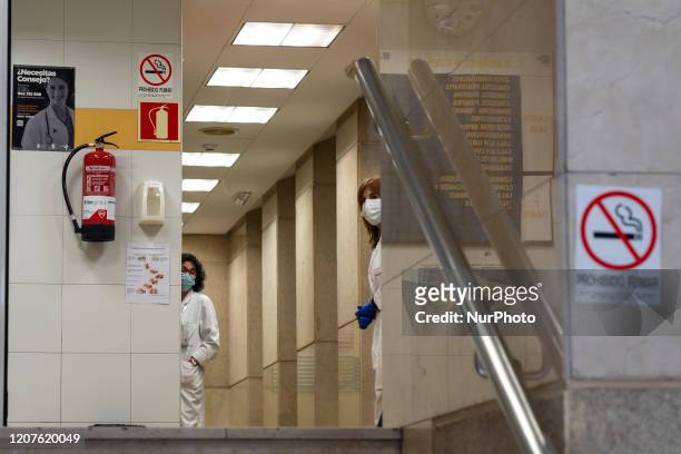 Two employees of a health center carry out their work in the city of Santander, Spain on March 18, 2020 complying with the safety and hygiene...