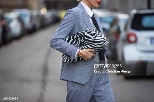 Viktoria Rader wearing grey suit, tie bag with zebra print outside Max Mara during Milan Fashion Week Fall/Winter 2020-2021 on February 20, 2020 in...