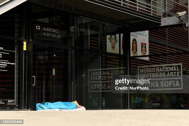 Homeless person sleeping at the Reina Sofia Museum in Madrid on March 18, 2020.