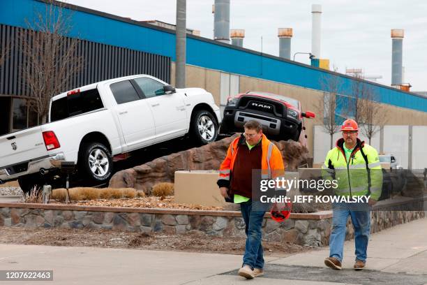 Construction workers leave FCA Chrysler Warren Truck Assembly after the Detroit three automakers have agreed to UAW demands to shut down all North...