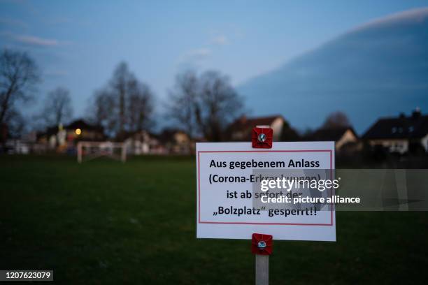 March 2020, Bavaria, Unterhaid: On a soccer field in Unterhaid a sign with the inscription "For given reason the "Bolzplatz" is closed from now on!!...