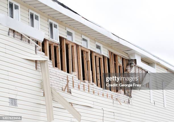 Siding hangs from a building that was damaged by an earthquake on March 18, 2020 in Magna, Utah. A 5.7-magnitude earthquake hit the Salt Lake Valley...