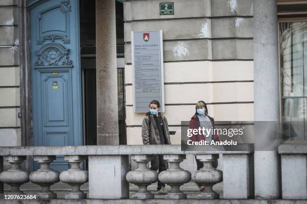 People wear face masks as a precaution against coronavirus in Ljubljana, Slovenia on March 18, 2020.