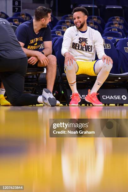 Assistant coach for player development Chris DeMarco shares a laugh with Stephen Curry of the Golden State Warriors before the game on March 1, 2020...