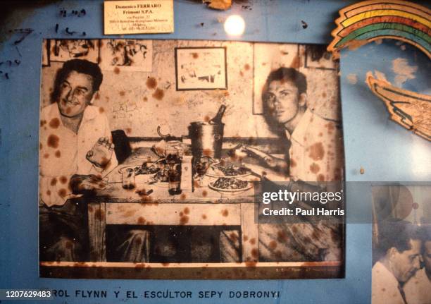 Errol Flynn picture on the wall of Ernest Hemingway's favorite bar Bodeguita del medio a storied watering hole with writing on the walls,Ernest...