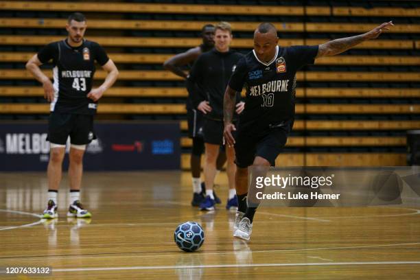 Former Socceroo Archie Thompson attempts a penalty kick during a Melbourne United NBL media opportunity at the Melbourne Sports and Aquatic Centre on...