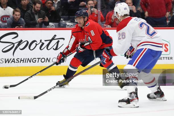 Alex Ovechkin of the Washington Capitals skates in front of Jeff Petry of the Montreal Canadiens during overtime at Capital One Arena on February 20,...