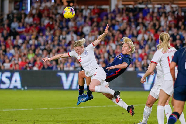 United States midfielder Lindsey Horan battles with England forward Ellen White in an attempt to bicycle kick the ball during the Women's SheBelieves...
