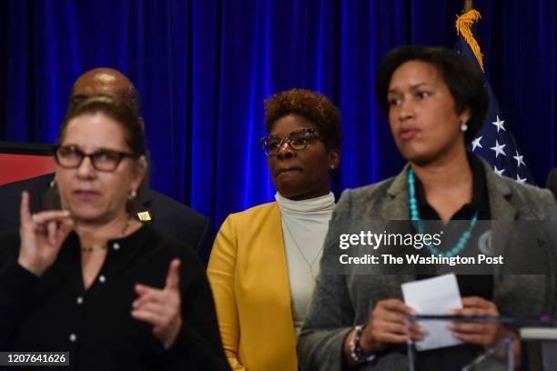 Dr. LaQuandra Nesbitt, C, director of the District of Columbia Department of Health, joins DC mayor Muriel Bowser and other District officials in...