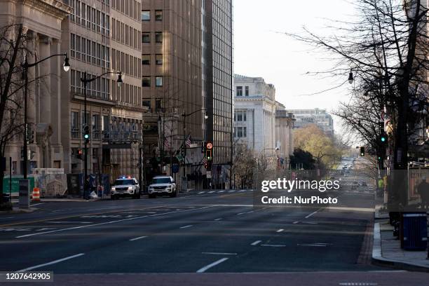 Few pedestrians walk through streets during what would normally be the morning rush after most businesses have required employees to work from home...