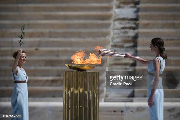 Greek actress Xanthi Georgiou , dressed as an ancient Greek high priestess lights the olympic torch during the Flame Handover Ceremony for the Tokyo...