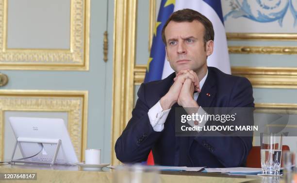 French president Emmanuel Macron, takes part on a videoconference of the "economic task force", in the green Presidential meeting room, at the Elysee...