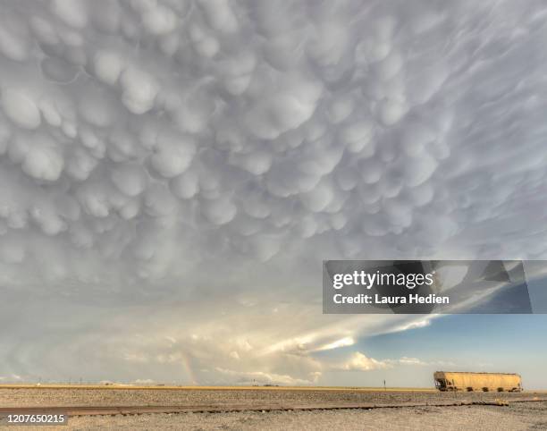 mammatus clouds and a rail car - mammatus cloud stock pictures, royalty-free photos & images
