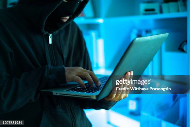 hacker with laptop, concept - data breach stock pictures, royalty-free photos & images