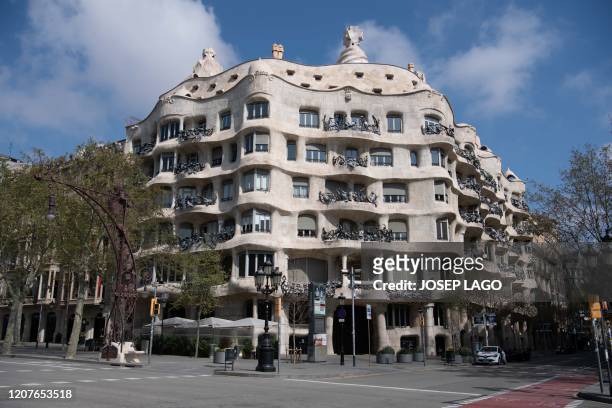 The empty street is pictured in front of Spanish architect Antonio Gaudi's "Casa Mila" building, commonly known as "La Pedrera", in Barcelona on...