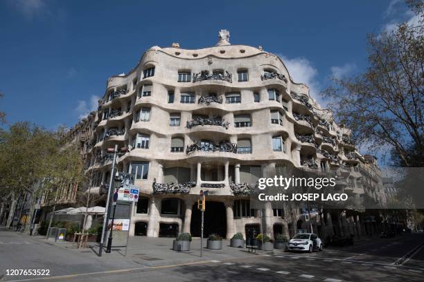 The empty street is pictured in front of Spanish architect Antonio Gaudi's "Casa Mila" building, commonly known as "La Pedrera", in Barcelona on...