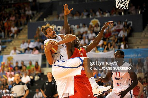 French national team's player Joakim Noah vies for the ball with Spain's player Serge Ibaka during a friendly basket ball game in preparation for...