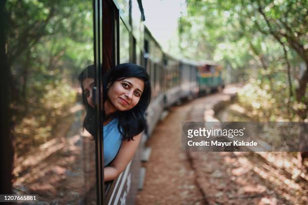 woman travelling by tourist train - miniature train stock pictures, royalty-free photos & images