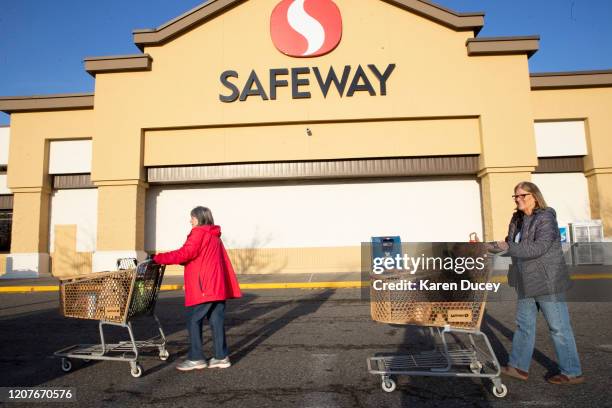 Vicki Phillips and her friend Wendy Priest take advantage of senior shopping hours at a Safeway grocery store early in the morning on March 19, 2020...