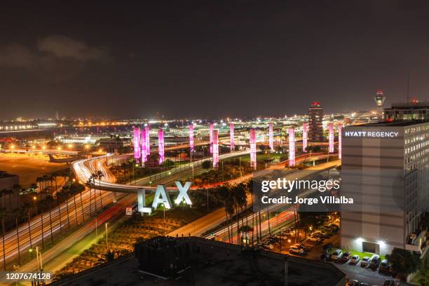 lax los angeles international airport sign and pylons at night - lax airport stock pictures, royalty-free photos & images