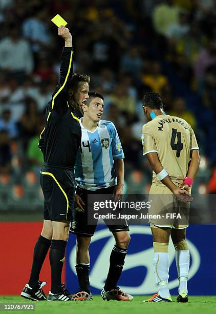 Referee Markus Strombergsson shows a yellow card for both Adrian Martinez of Argentina and Mohamed Abdel Fatah of Egypt during the FIFA U-20 World...