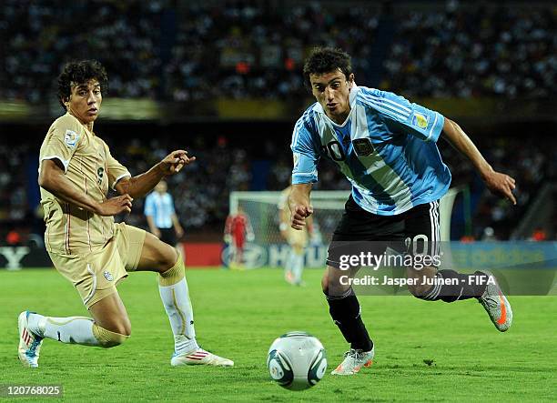 Carlos Luque of Argentina duels for the ball with Ahmed Sohby of Egypt during the FIFA U-20 World Cup Colombia 2011 round of 16 match between...