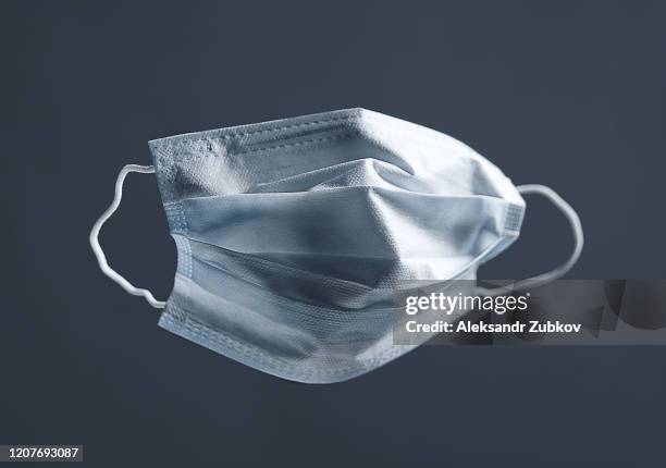 medical used face mask, protects against virus. concept of air pollution, pneumonia outbreaks, coronavirus epidemics, and the risk of biological contamination. - air pollution mask stockfoto's en -beelden