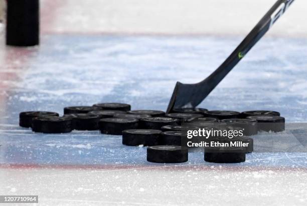 Hockey pucks are gathered in the crease during warmups before a game between the Tampa Bay Lightning and the Vegas Golden Knights at T-Mobile Arena...