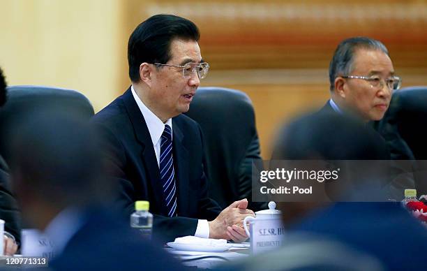 Chinese President Hu Jintao addresses his counterpart from Mozambique, President Armando Guebuza, during their meeting at the Great Hall of the...