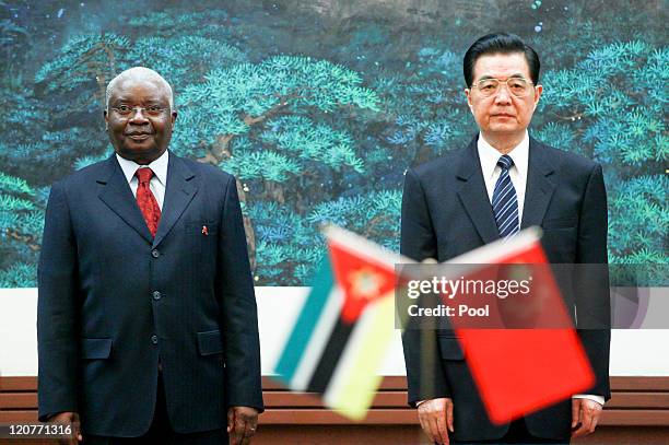 President of Mozambique Armando Guebuza and Chinese President Hu Jintao stand together during a signing of agreements at the Great Hall of the People...