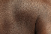 Texture of human skin. Close up of african-american male body